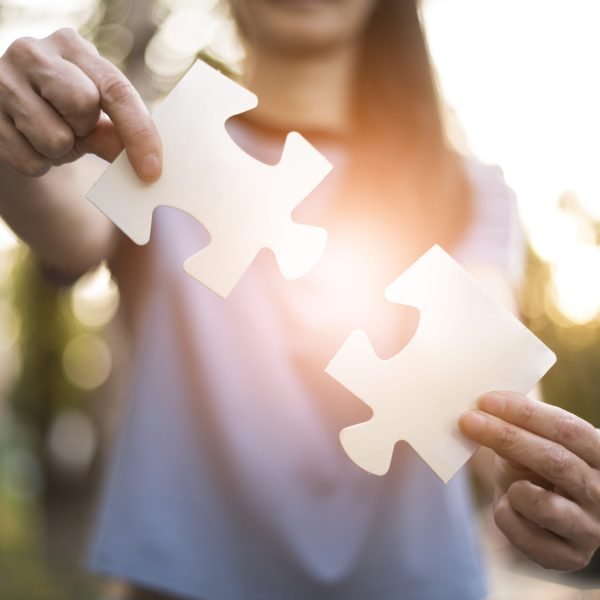 front-view-woman-holding-puzzle-pieces front-view-woman-holding-puzzle-pieces