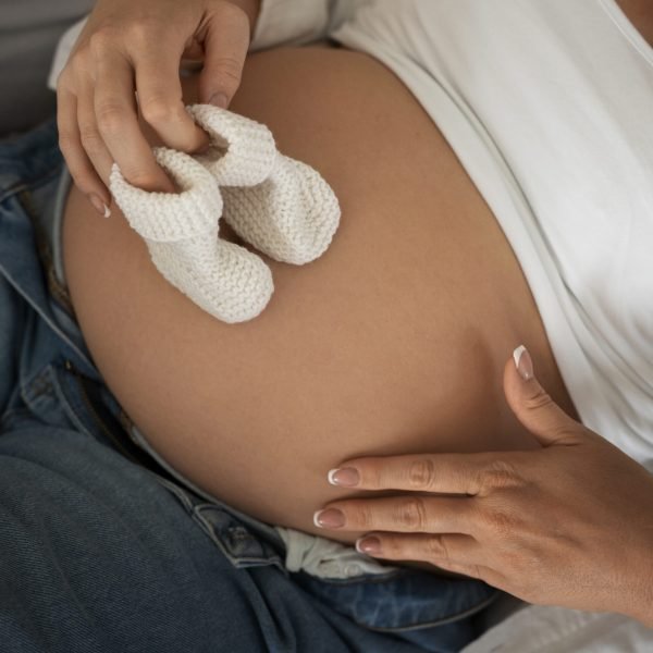 high-angle-pregnant-woman-spending-time-indoors