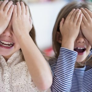 Little girls playing hide and seek