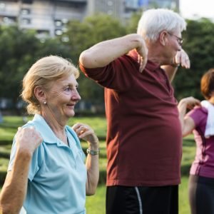 Group of senior friends stretching together in a park