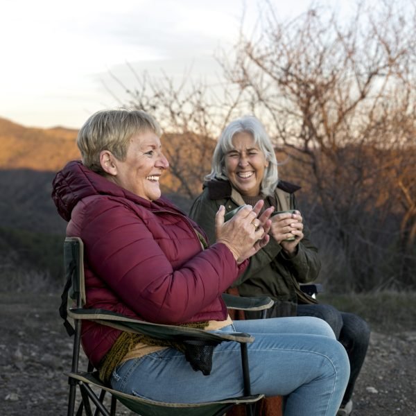 two-senior-woman-nature-escapade-sitting-chairs-enjoying-their-time